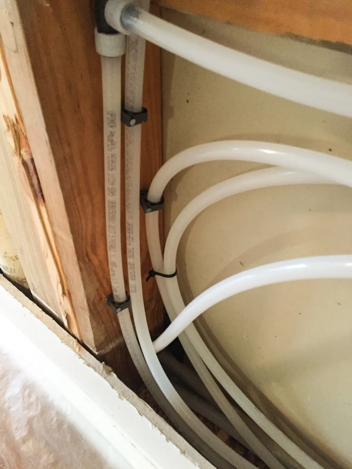 PEX repipe lines looped through wall framing before drywall, from our Newport Beach guide: Selling a Newport Beach Home With Old Plumbing