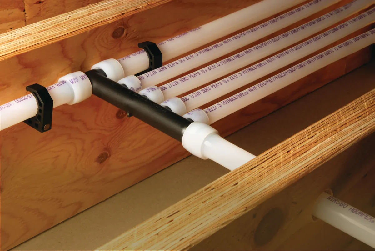 PEX-A multiport tee distributing water lines along joists – Rinnai Tankless Water Heater Installation Guide for Newport Beach Homeowners for Newport Beach, CA homes